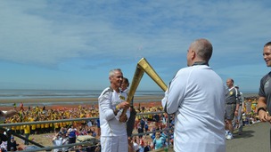 Man and small boy holding torch