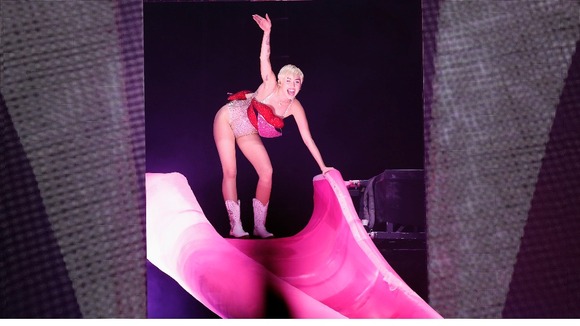 Former Hannah Montana star Miley Cyrus made an entrance by sliding down a replica of her own tongue.