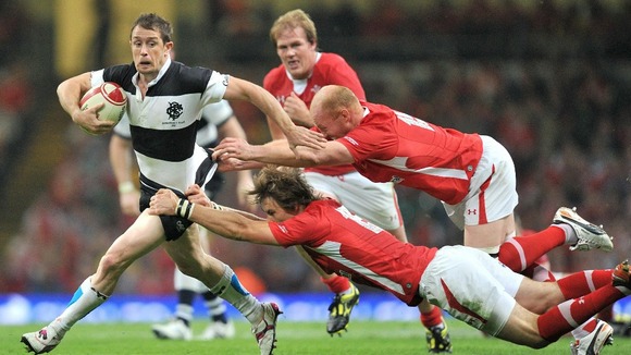 Wales' Liam and Martyn Williams tackle the Barbarians' Shane Williams