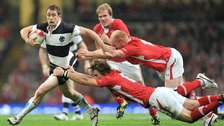 Wales' Liam and Martyn Williams tackle the Barbarians' Shane Williams