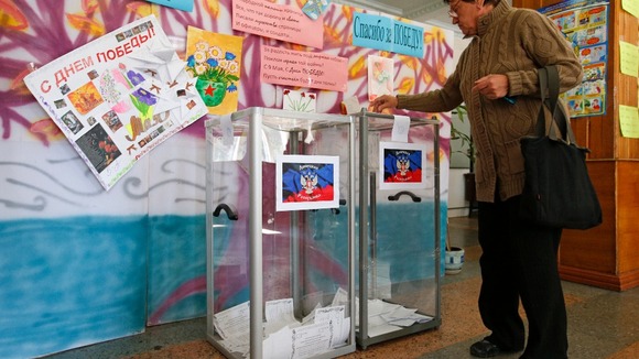 Votes are placed in clear boxes during open ballots.