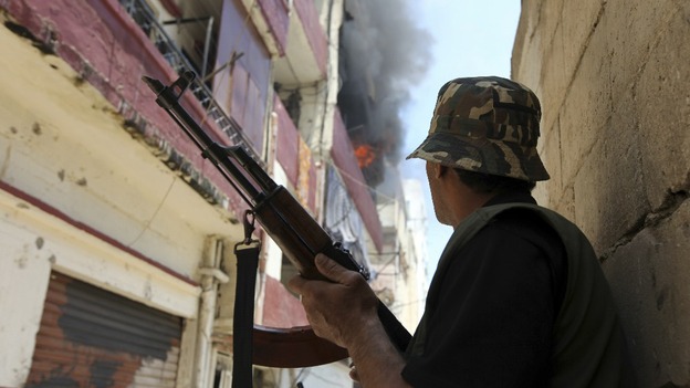 A Sunni gunman is seen near a burning building during the clashes.