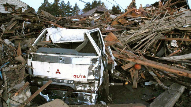 A truck and destroyed buildings swept by a tsunami following Japan's earthquake last year