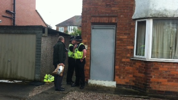 Police outside the boarded up house