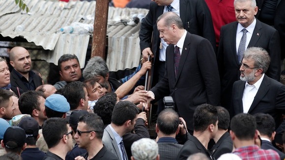 Turkey's Prime Minister Tayyip Erdogan (centre) talks with relatives of miners who were killed or injured in the Soma mine explosion