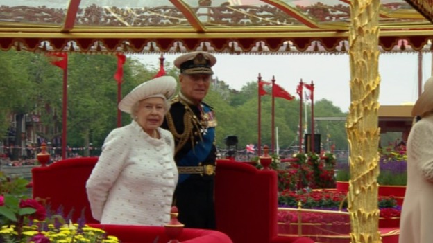 The Queen and the Duke of Edinburgh watch the row boats and Gloariana begin the River Pageant