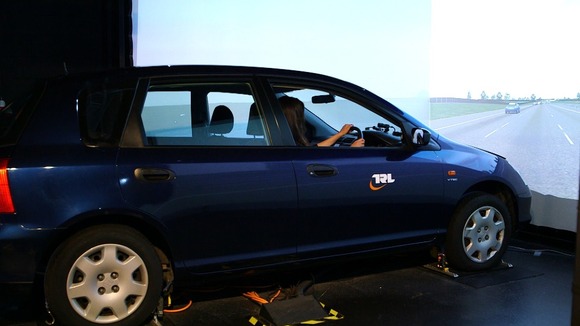 Woman driving simulator car