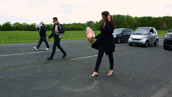 Three people walking down track with balloons