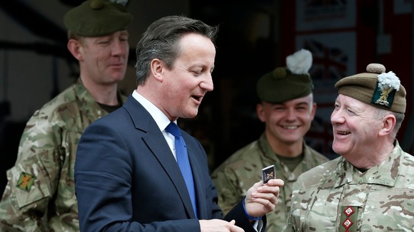 David Cameron jokes with members of the Armed Forces on his visit today.
