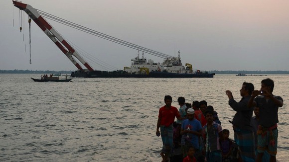 People look on as the rescue operation to find survivors continues.