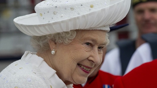 The Queen smiles as she arrives for the River Pageant