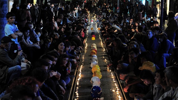 Demonstrators light candles in memory of the mine victims during a sit-in protest in Istanbul.