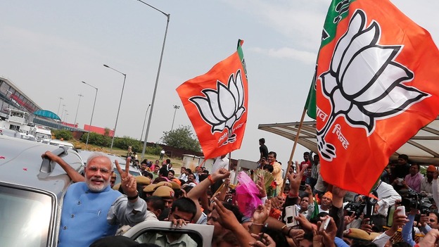 Hindu nationalist Narendra Modi gestures from his car during the parade.