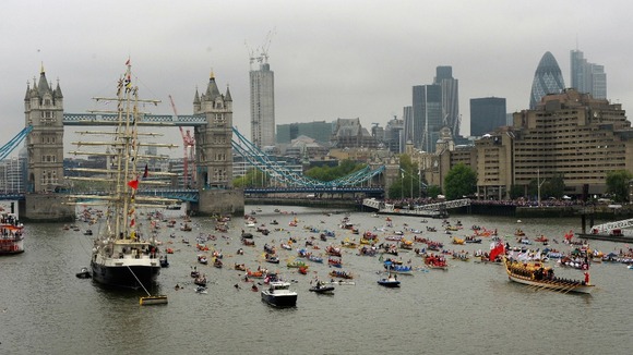 The Gloriana, the £1 million row barge, leads the manpowered section of the Diamond Jubilee River Pageant along the River Thames.
