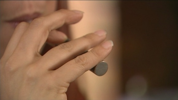 A woman uses an e-cigarette