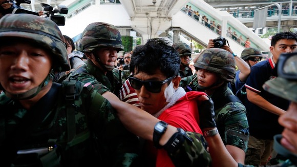 Soldiers detain an activist during the protests in Bangkok.