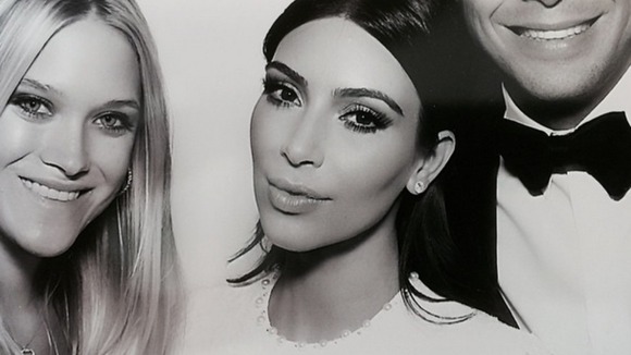 Bride Kim Kardashian poses in a photo booth with guests at her wedding to Kanye West yesterday in Florence.