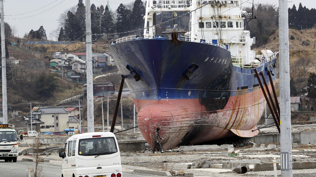 Cars pass by the 330 ton and 60-meter (200 feet) fishing vessel