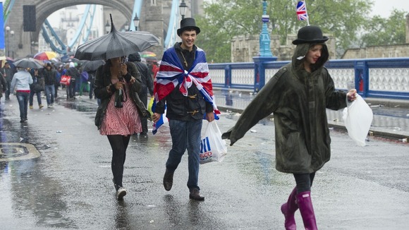 Rain soaks revellers celebrating the queen's Diamond Jubilee, after they watched the river pageant at Tower Bridge in London.