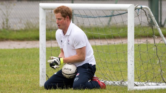 Prince Harry enjoyed a game of football with young children in Suffolk yesterday.