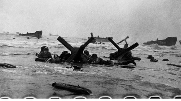Soldiers take cover as they advance to shore.