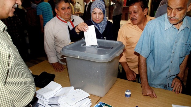 A Syrian woman casts her vote.