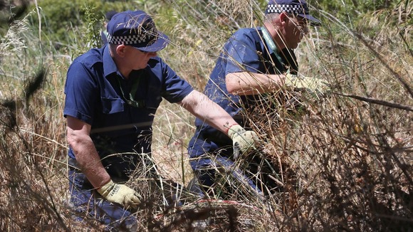 Police were seen searching one particular area of the cordoned-off wasteland.