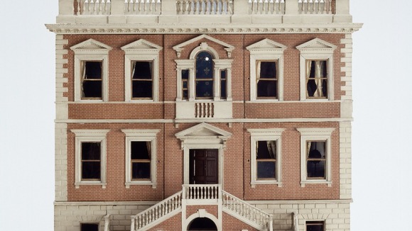 The dolls' house includes original wallpapers and painted paneling in the style of Robert Adam and a lying-in room for a pregnant doll.