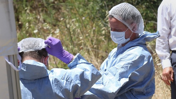 Forensic police officers preparing to examine a hole in Praia da Luz in Portugal.