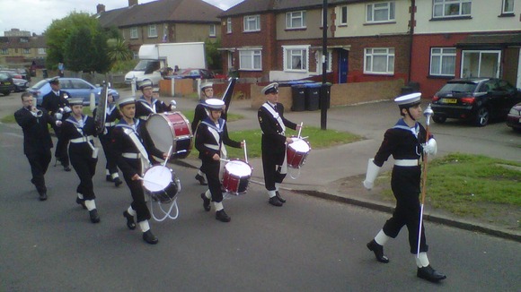 Sea cadets march to their street party in Enfield.