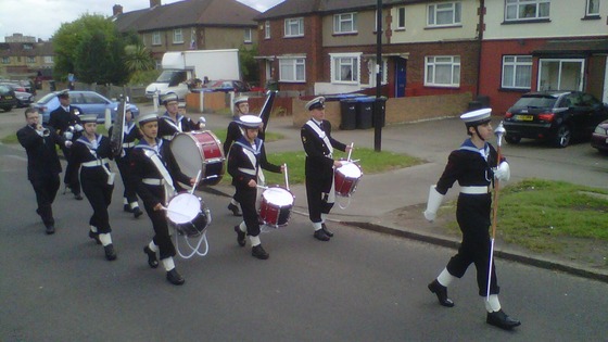 Sea cadets march to their street party in Enfield.