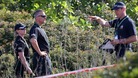 British police check an area of scrubland during the search for evidence of Madeleine McCann, in the town of Praia da Luz in Portugal.