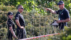 British police check an area of scrubland during the search for evidence of Madeleine McCann, in the town of Praia da Luz in Portugal.