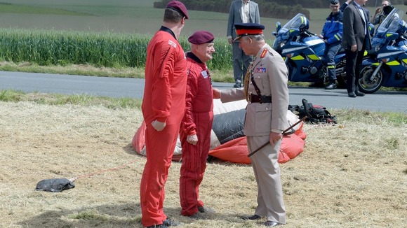 The Prince of Wales greets Jock after his landing.