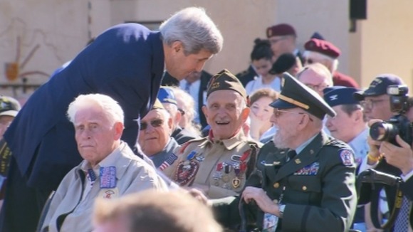 US Secretary of State John Kerry laughs with D-Day veterans on the 70th anniversary of the landings.