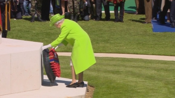 The Queen lays a wreath as the ceremony takes place.