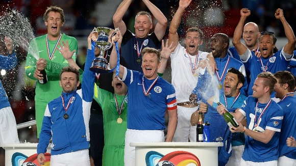 Rest of the World's Michael Sheen and Gordon Ramsay lift the Soccer Aid trophy
