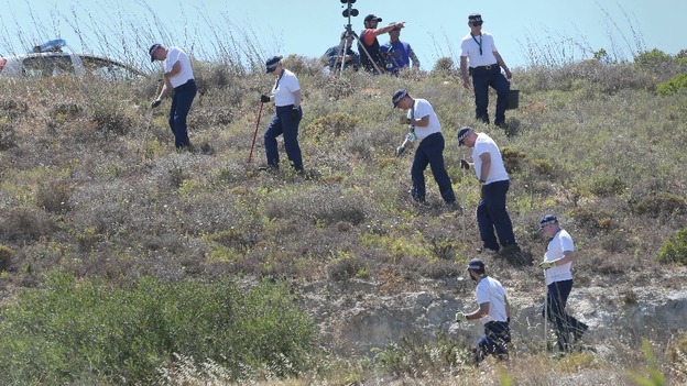 British police officers pictured searching an area of scrubland last week in the hunt for Madeleine McCann.
