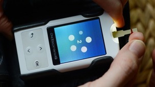 A woman measures her blood sugar levels.