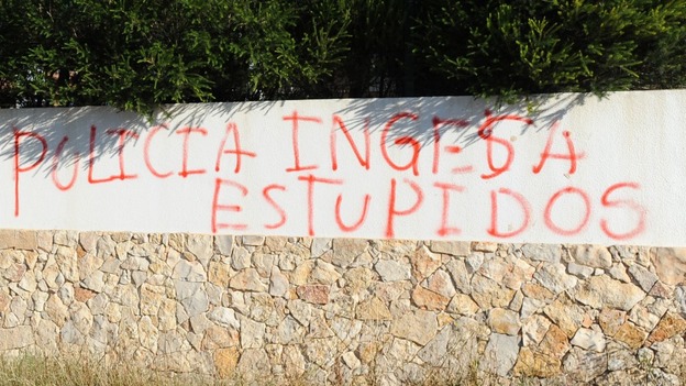 Graffiti scrawled on a wall overlooking the new search site accuses British police of being stupid.