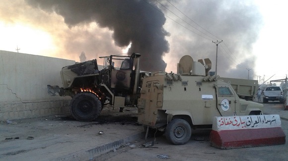 Damaged vehicles belonging to Iraqi security forces seen during yesterday's clashes.