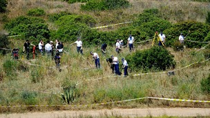British police and their Portuguese counterparts search a patch of scrubland in the Madeleine McCann investigation.