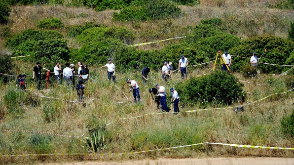 British police and their Portuguese counterparts search a patch of scrubland in the Madeleine McCann investigation.