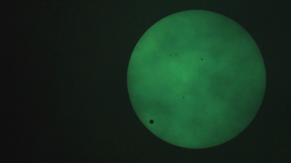 The planet Venus transits across the sun, as seen through a welding filter in Sydney