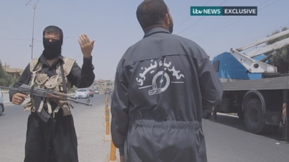 Islamist militant waves traffic through.