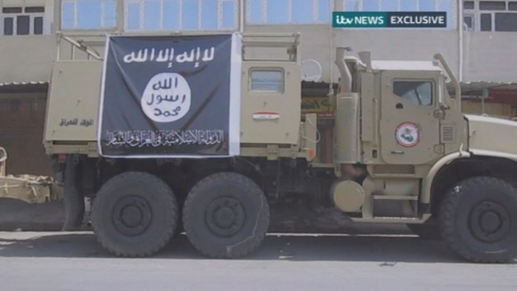 An Iraqi military vehicle with the ISIS logo attached onto it.