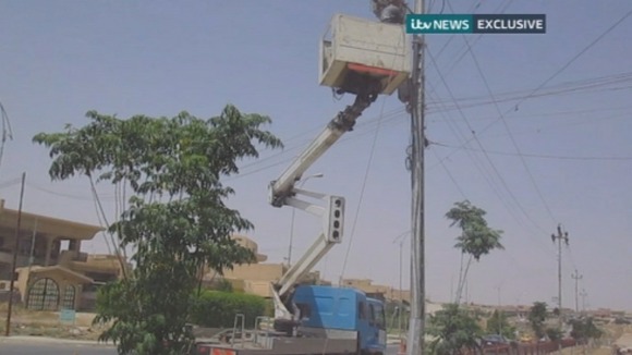 A utility worker on a cherry picker tries to restore electricity to the areas of Mosul with no power.
