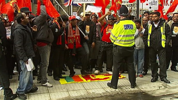 Demonstrators stamping on the Sri Lankan flag.
