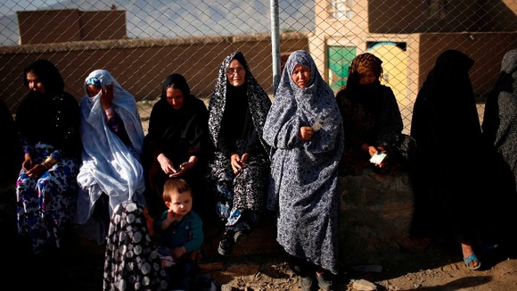 Afghan women wait in line to cast their votes at a polling station in Kabul today.
