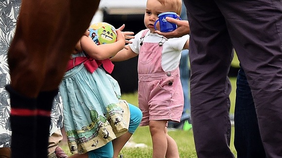 The young prince is seen with a young friend at the match.